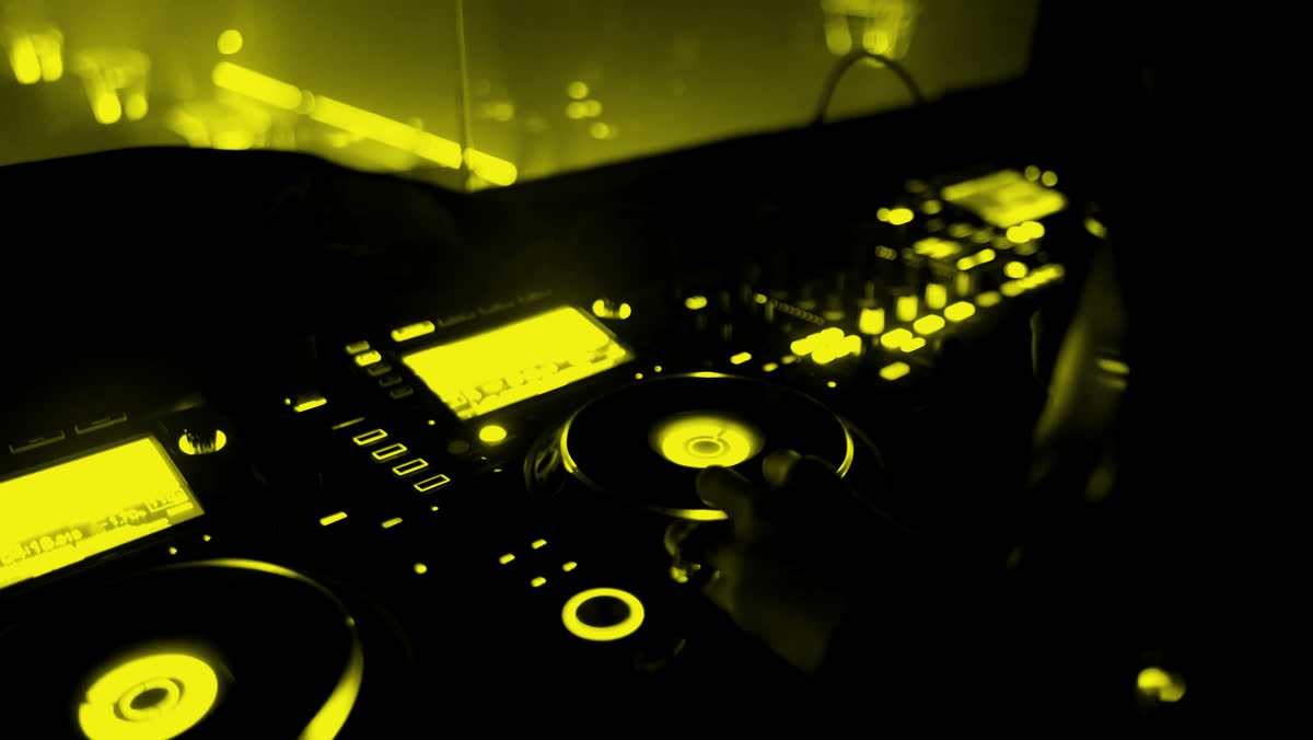 DJ decks at night, yellow duotone